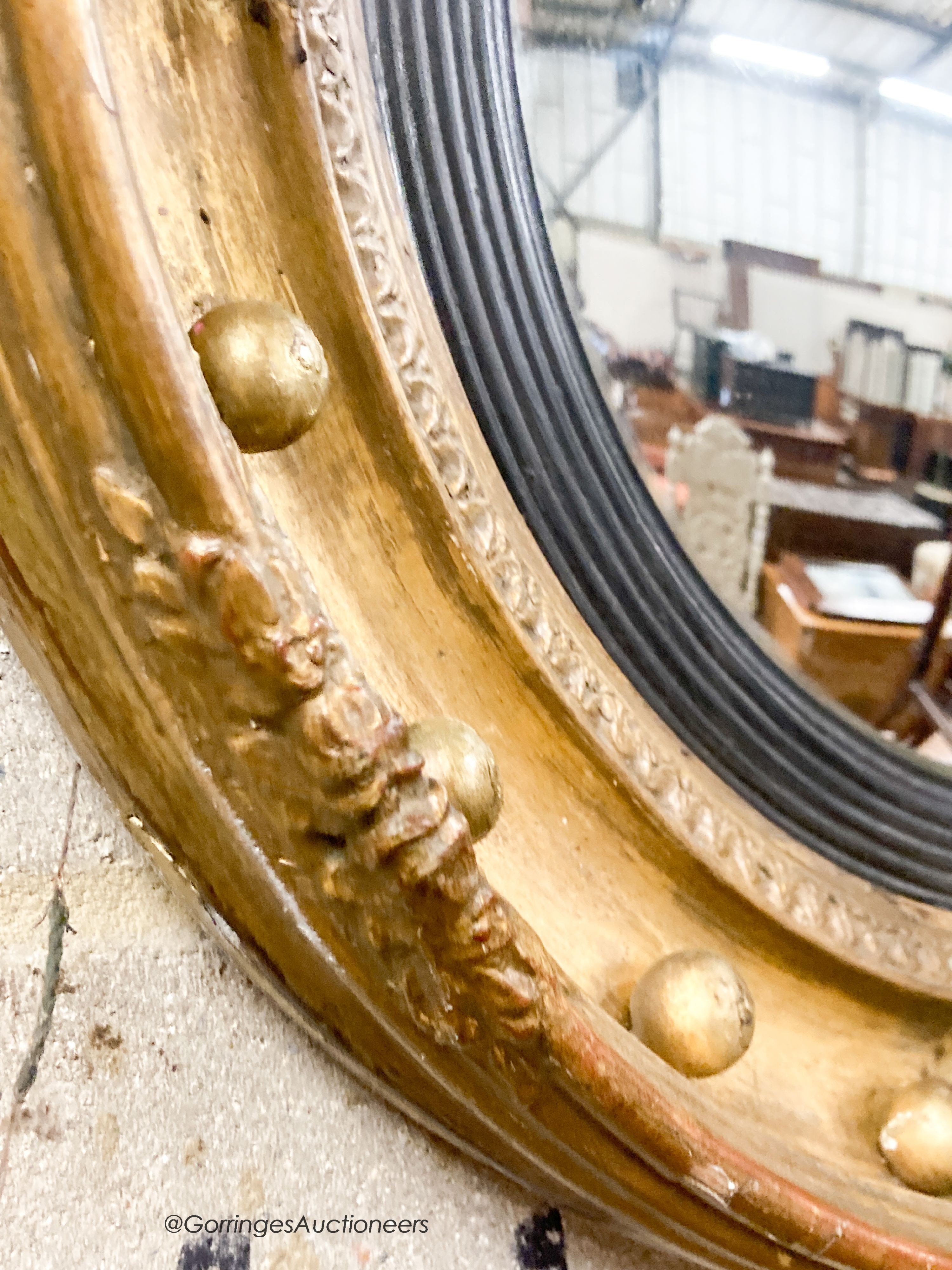 A Victorian giltwood and gesso convex wall mirror, diameter 47cm